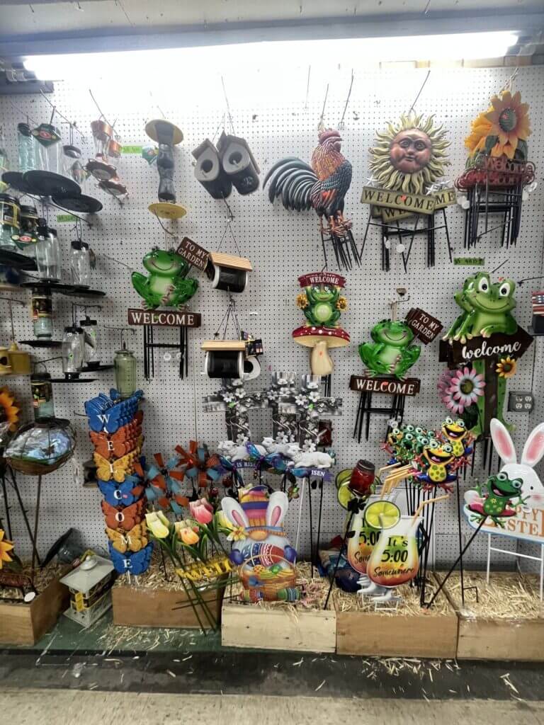 Colorful garden stakes and welcome signs display