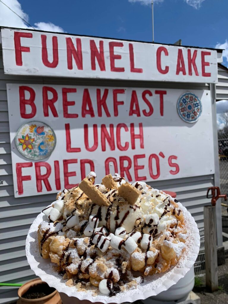Funnel cake topped with marshmallows and chocolate