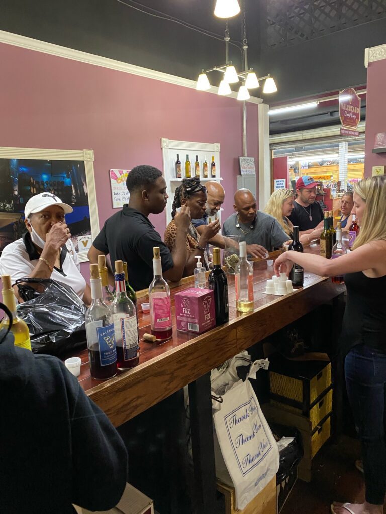 Customers sampling wines at bustling tasting bar